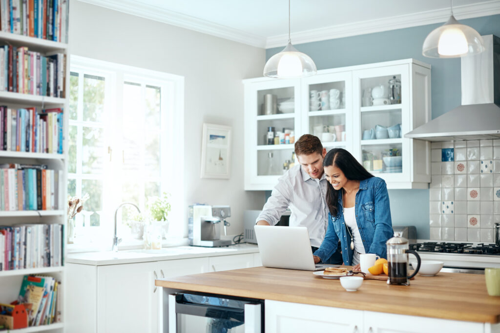 Shot of a couple using a laptop together at home
