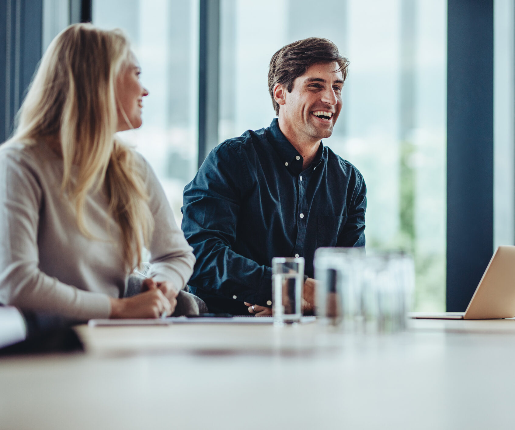 Businessman smiling during a meeting. Business people smiling after a productive meeting in a conference room.